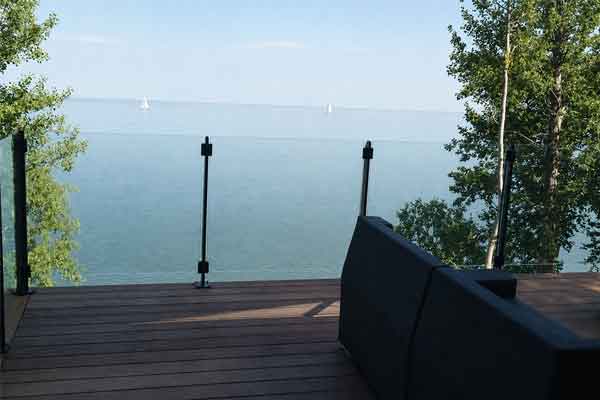 Frameless tempered glass railing surrounds 20 by 14 foot deck on Lake St. Clair in Lakeshore, ON.