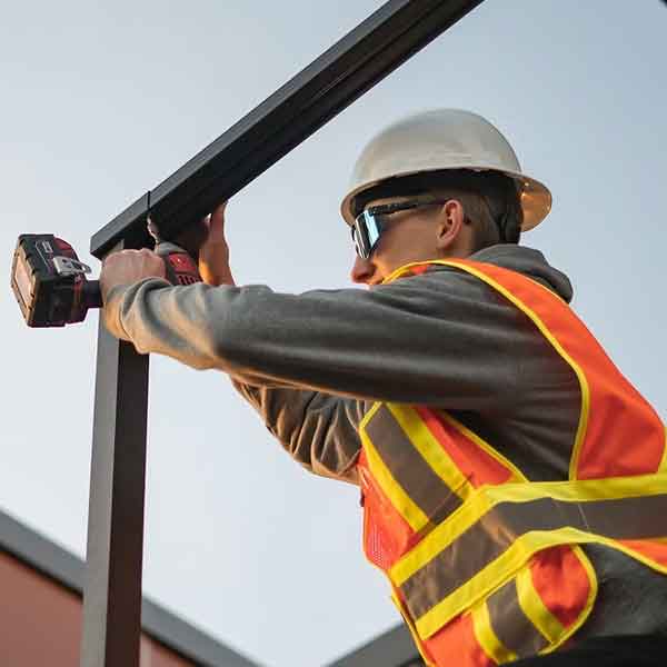 Man installing commercial railings in Ontario.