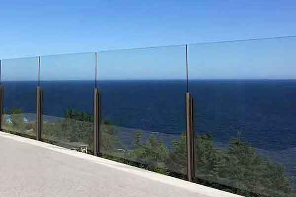 Tinted semi-frameless tempered glass railing installed on lakefront home in Wheatley, Ontario.