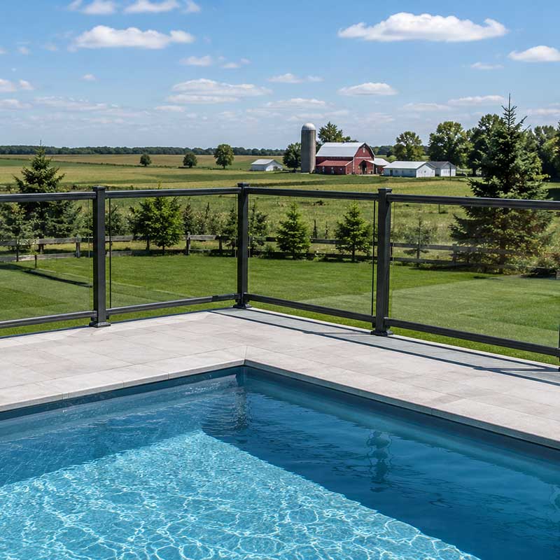 Aluminum tempered glass railing surrounding pool in Chatham Ontario.